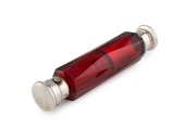 An antique faceted ruby glass double ended scent bottle with silver tops, 19th century, 14.5cm long.