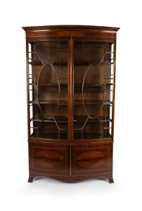 A handsome antique English Sheraton Revival bow fronted mahogany display cabinet with astragal glazed doors, late 19th century, 223cm high, 135cm wide, 40cm deep.