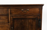 An antique English oak kitchen dresser base with cockbeaded drawers and brass swing handles, 18th/19th century, 86cm high, 170cm wide, 52cm deep. - 2