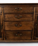 An antique English oak kitchen dresser base with cockbeaded drawers and brass swing handles, 18th/19th century, 86cm high, 170cm wide, 52cm deep. - 3