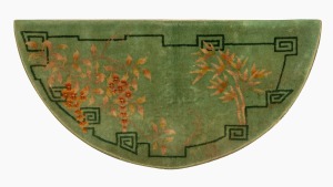 A Chinese Art Deco demi-lune woollen rug with bamboo and wisteria decoration on sage green ground, 67 x 138cm