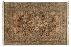 An ornate hand-knotted pure silk rug on black and beige ground, 190 x 123cm