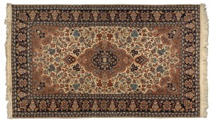 A Persian hand-knotted wool rug with cream and blue ground, ​​​​​​​220 x 124cm
