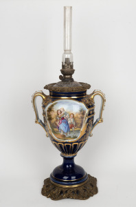 An antique blue and white porcelain based oil lamp with hand-painted scene and gilt metal mounts, 19th century, ​​​​​​​60cm high overall.