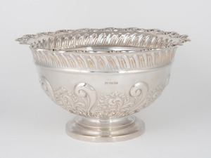 An antique English sterling silver rose bowl with repousse decoration, made in Sheffield, circa 1900, 14cm high, 25cm wide, 695 grams.