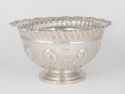 An antique English sterling silver rose bowl with repousse decoration, made in Sheffield, circa 1900, ​​​​​​​14cm high, 25cm wide, 695 grams.