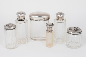 Six assorted antique silver topped glass vanity jars, including an attractive intaglio cut example, 19th/20th century, A/F, the largest 10cm high.