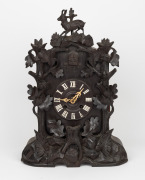 BLACK FOREST antique German cuckoo clock with carved mountain goat finial and twin train movement, 19th century, 49cm high.