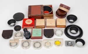 ZEISS IKON: An accumulation of twenty-six different camera attachments, including many lens filters in plastic cases or maker's boxes, lens hoods, one right-angle finder, and others. (26 items)