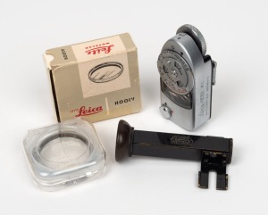 LEITZ: Group of three camera attachments - one WINKO angle finder in black, one HOOIV UVa lens filter in maker's box with plastic case, and one Leica-Meter MC. (3 items)