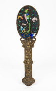 An antique Chinese hand-mirror with enamel bird and floral decoration and repousse brass handle, 19th/20th century, 32cm high.