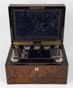 An antique English brass bound burr walnut travelling vanity box, interior finished in plush royal blue velvet with lift-out tray and compartments housing a series of silver plated jars and bottles with press button release jewellery drawer, mid 19th cent