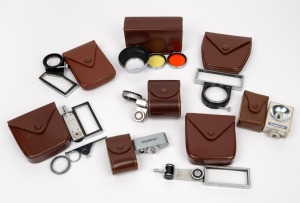 VOIGTL&Auml;NDER: An accumulation of eight camera attachments, all in original Voigtl&auml;nder leather pouches, including 310/37 lens hood and lens filter kit, 93/184 rangefinder attachment, several types of Proximeter, and others. (8 items)