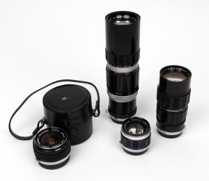 OLYMPUS: Group of four lenses, all with Olympus rear caps - one Zuiko Zoom 100-200mm f5, one Zuiko Auto-Zoom 50-90mm f3.5, one G. Zuiko Auto-S 40mm f1.4, and one OM-System G. Zuiko Auto-W 28mm f3.5 with Olympus leather lens container. (4 items)