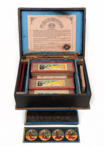 MAGIC LANTERN SLIDES: Group of sixty magic lantern slides, the largest 20 x 6cm, including of note one chromatrope, in maker's timber box.