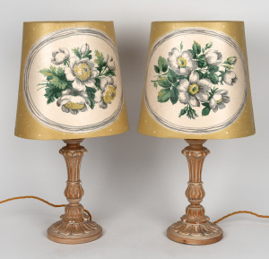 A pair of carved wooden table lamps with Sanderson floral linen covered shades, 20th century, 56cm high overall.