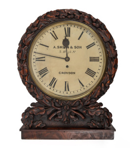 An antique English single train fusee mantle clock with attractively carved oak case on flame mahogany base, original cast brass bezel with separated case hinge, mid 19th century, 53cm high, 31cm bezel.