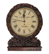 An antique English single train fusee mantle clock with attractively carved oak case on flame mahogany base, original cast brass bezel with separated case hinge, mid 19th century, 53cm high, 31cm bezel.