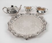 A silver plated three piece tea service on an attractive and handsomely engraved serving tray, 19th/20th century, (4 items), the tray 42cm wide