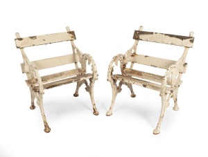 A pair of antique English cast iron "Berry and Leaf" garden armchairs with remains of white painted finish, 19th century, (heavy), 89cm high, 54cm across the arms.