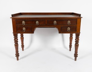 An antique English mahogany four drawer desk with gallery tray back and embossed leather top, 19th century, 80cm high, 111cm wide, 50cm deep.