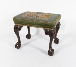 A Georgian Revival carved mahogany footstool on cabriole legs with ball and claw feet, green velvet upholstery with tapestry top, early to mid 20th century, 48cm high, 57cm wide, 43cm deep.