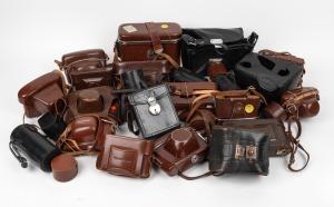 VARIOUS MANUFACTURERS: An accumulation of twenty-eight leather camera, lens, and accessory cases, from manufacturers such as Olympus, Voigtl&auml;nder, and Zeiss Ikon. (28 items)