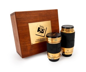 VIVITAR: Two 1988 50th-anniversary Series 1 gold-plated brass zoom lenses with front and back lens caps, presented in original wooden, black velvet-lined box. Each lens bears an engraved serial number indicating it to be the 13th of 15 produced. This spec