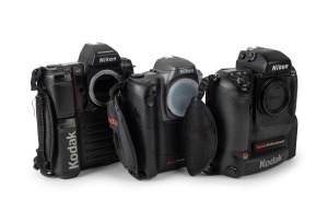 NIPPON KOGAKU: Group of three camera bodies with Kodak digital camera backs - one Nikon F5 with body cap coupled to Kodak DCS 760 [#K760C-04198], one Nikon F-801s coupled to Kodak DCS 200 [#K380-8137], and one Nikon Pronea 6i with body cap coupled to Koda