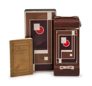 KODAK: No. 1A Gift Kodak 116 film camera with original brown bellows and well-preserved enameled metal Art-Deco inlay on front door and faceplate, c. 1930. Offered with instruction booklet and original cedar box, which repeats the beautiful Art-Deco desig
