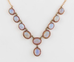 An Italian 9ct yellow gold choker necklace, set with nine solid polished opals each surrounded with rubies, 20th century, ​​​​​​​28cm long, 13.4 grams total.