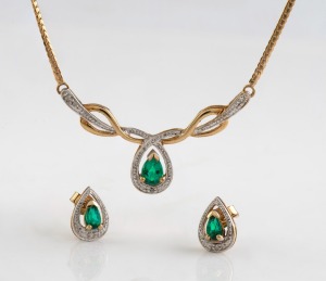 A 9ct yellow gold and emerald necklace together with matching earrings, stamped "375", ​​​​​​​the necklace 40cm long, 5.4 grams total.