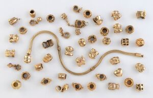 PANDORA 14ct yellow gold bracelet and a large quantity of charms, 162 grams total.