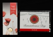 REMEMBRANCE DAY: Group of two RAM carded coloured coins, comprising 2011 $5 uncirculated Remembrance Day, together with 2015 $2 circulating 'Lest We Forget - Poppy' counterstamp. (2 items)