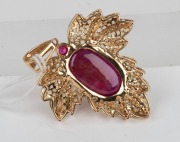 An 18ct yellow gold pendant, set with an impressive cabochon natural ruby, surrounded by alternating rows of brilliant cut diamonds and peridots, 5.5cm high overall, 15.4 grams. - 2