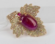 An 18ct yellow gold pendant, set with an impressive cabochon natural ruby, surrounded by alternating rows of brilliant cut diamonds and peridots, 5.5cm high overall, 15.4 grams. - 3