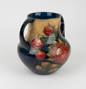 MOORCROFT "Protea" rare twin-handled English pottery vase, finely decorated with large protea flowers and the reverse decorated with a spray of African Lilies, circa 1928, impressed signature mark to base "W. Moorcroft, Potter to H. M. The Queen. Made in - 4