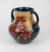 MOORCROFT "Protea" rare twin-handled English pottery vase, finely decorated with large protea flowers and the reverse decorated with a spray of African Lilies, circa 1928, impressed signature mark to base "W. Moorcroft, Potter to H. M. The Queen. Made in - 6
