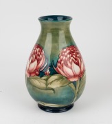 MOORCROFT "Waratah" baluster shaped English pottery vase on blue and green ground, impressed signature cartouche "W. Moorcroft, Potter to H. M. The Queen. Made in England" with underglazed blue signature mark "W. Moorcroft", 25cm high - 4