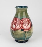 MOORCROFT "Waratah" baluster shaped English pottery vase on blue and green ground, impressed signature cartouche "W. Moorcroft, Potter to H. M. The Queen. Made in England" with underglazed blue signature mark "W. Moorcroft", 25cm high - 5
