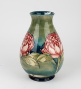 MOORCROFT "Waratah" baluster shaped English pottery vase on blue and green ground, impressed signature cartouche "W. Moorcroft, Potter to H. M. The Queen. Made in England" with underglazed blue signature mark "W. Moorcroft", 25cm high - 6