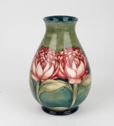 MOORCROFT "Waratah" baluster shaped English pottery vase on blue and green ground, impressed signature cartouche "W. Moorcroft, Potter to H. M. The Queen. Made in England" with underglazed blue signature mark "W. Moorcroft", 25cm high - 7