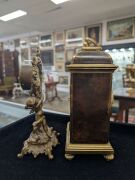 An antique French brown tortoiseshell and brass moulded miniature table clock with eight day time and gong striking movement with platform lever escapement; together with an American Ansonia time only cherub figural timepiece, (2 items), the larger 24cm i - 2