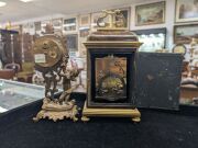 An antique French brown tortoiseshell and brass moulded miniature table clock with eight day time and gong striking movement with platform lever escapement; together with an American Ansonia time only cherub figural timepiece, (2 items), the larger 24cm i - 4