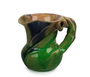 REMUED pottery jug with applied gumnuts, leaf and branch handle, glazed in striking early lime green and blue with pink highlights, original foil label affixed to the side, 10.5cm high