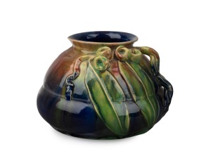 REMUED blue and green glazed pottery vase with pink highlights, decorated with four large gumnuts, two leaves and branch handle, incised "Remued Hand Made, 151LM", ​​​​​​​12cm high, 18cm wide.