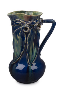 REMUED blue and green glazed pottery jug with three large applied gumnuts, two leaves and branch handle, incised "Remued, Hand Made, 153/M", 19.5cm high.