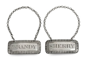 THOMAS ROBINSON (THE CONVICT SILVERSMITH) pair of sterling silver decanter labels, with attached bottle-neck chains, early 19th century, 5.5cm wide, 20.5 grams total.