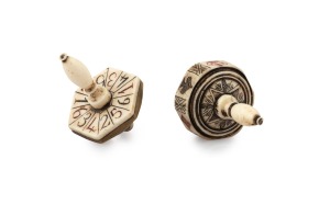 Two whalebone gaming tops, one example with brass fittings, 19th century, the larger 4.5cm high