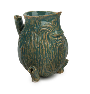 WILLIAM RICKETTS rare early green glazed pottery gumnut jug with Aboriginal face mask spout and stick decoration, incised "Wm. Ricketts, 1934", 9cm high